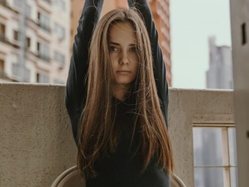 woman raising her hand holding