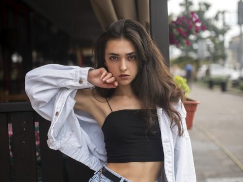 woman in white long sleeve shirt and blue denim skirt