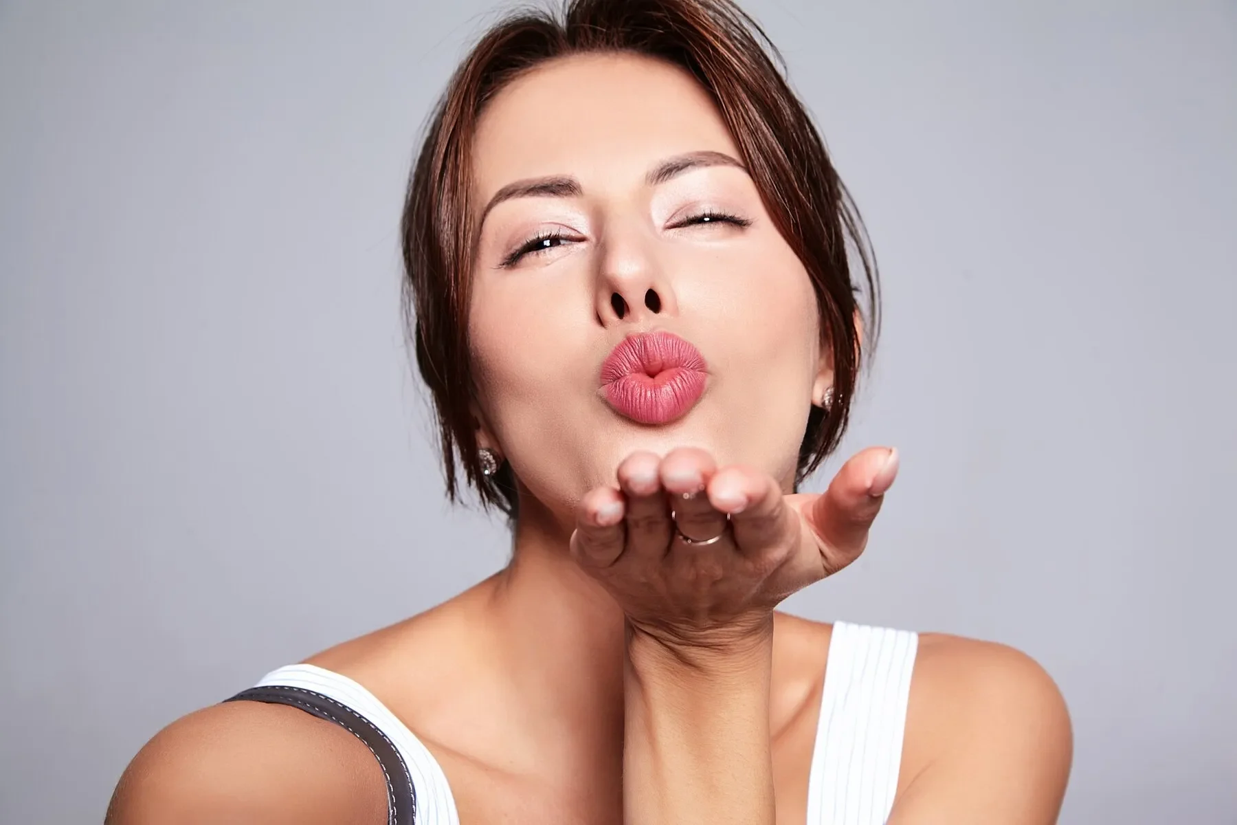 Portrait beautiful cute brunette giving air kiss