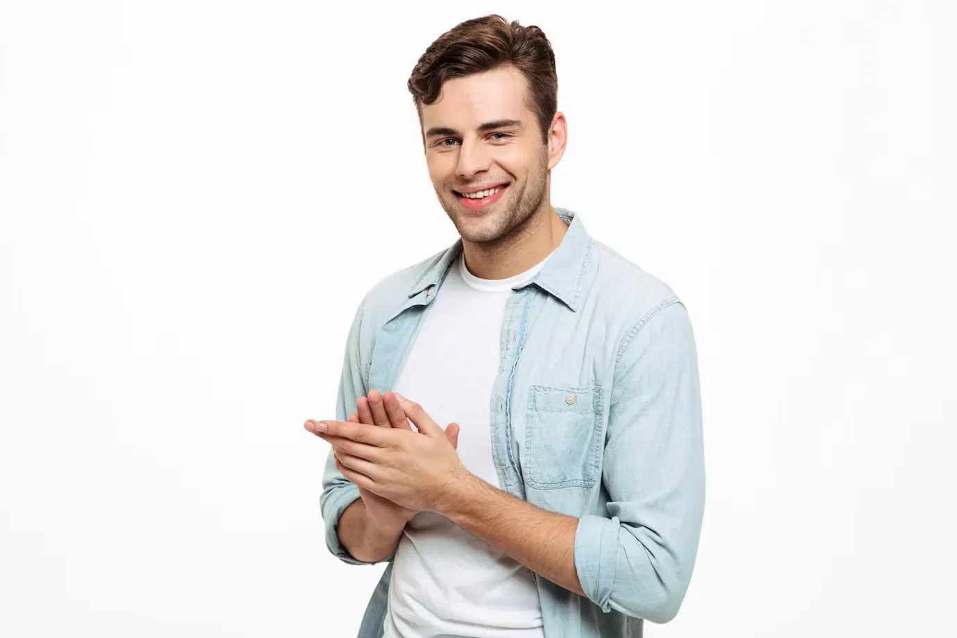 Portrait smiling young man rubbing his hands