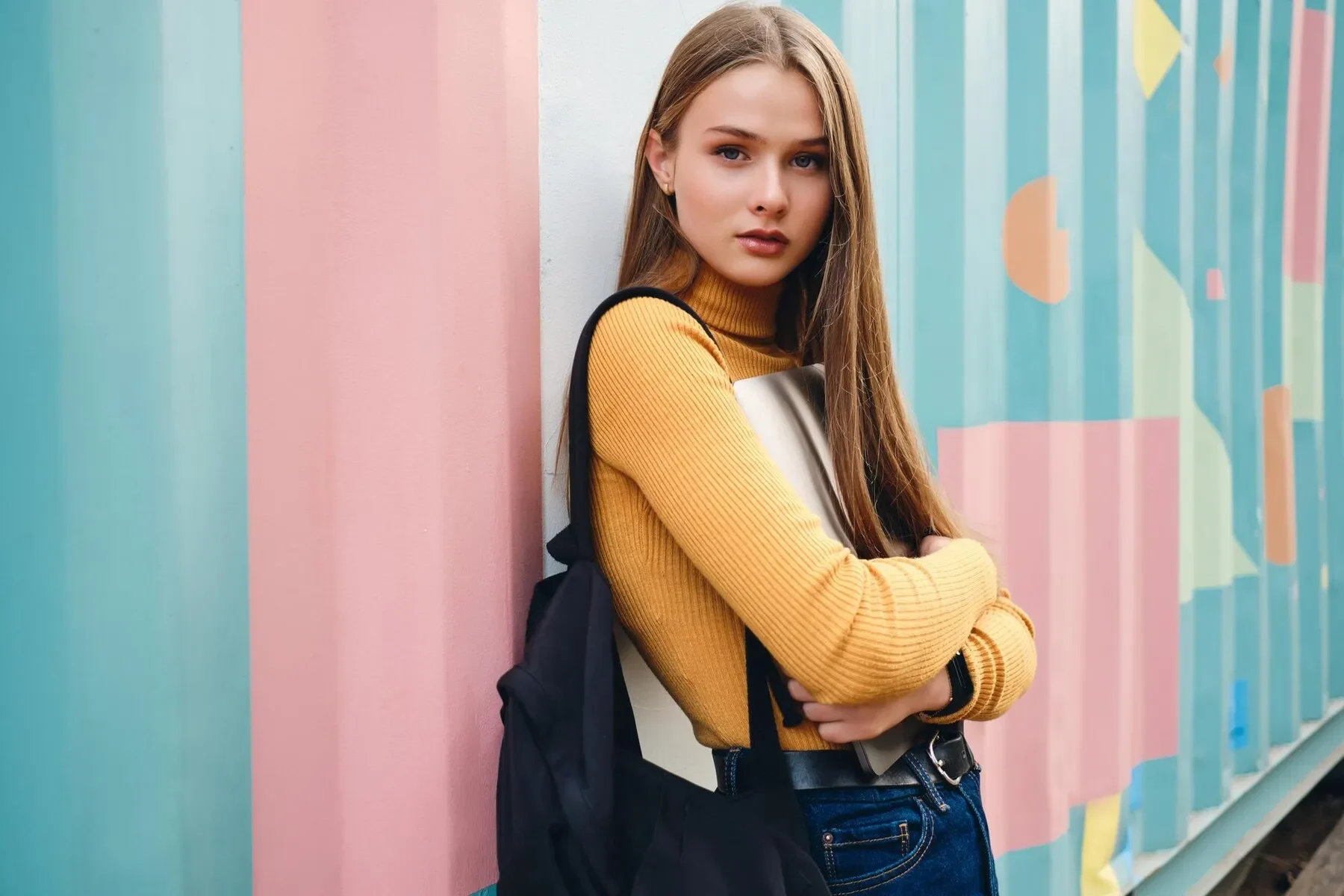Pretty casual student girl with laptop intently looking