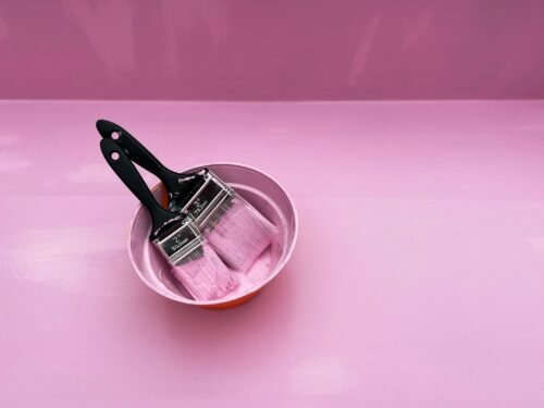 stainless steel cooking pot on pink round plate
