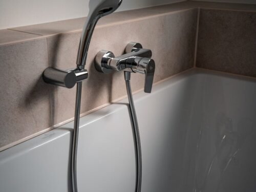 a close up of a bathtub with a shower head