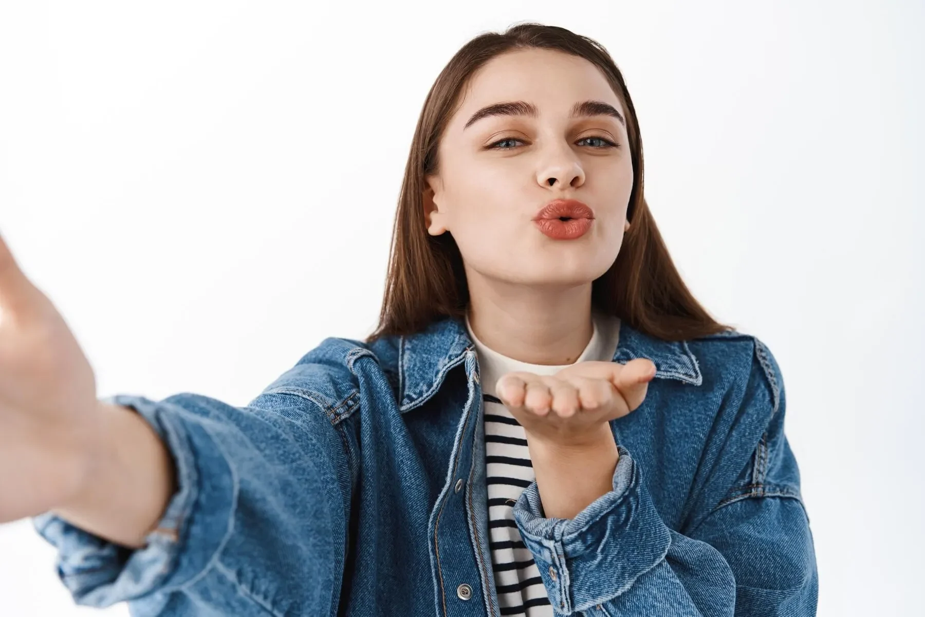 Sending kisses cute young woman taking selfie send