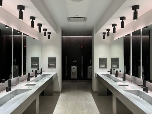 a large bathroom with sinks and mirrors