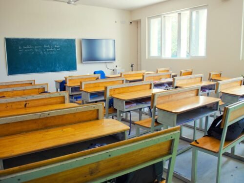A classroom filled with wooden desks and chairs