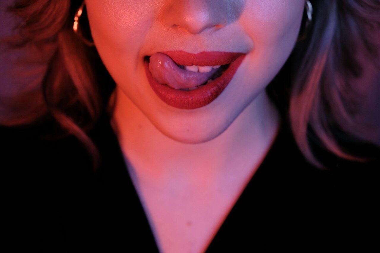 A woman sticks out her tongue.