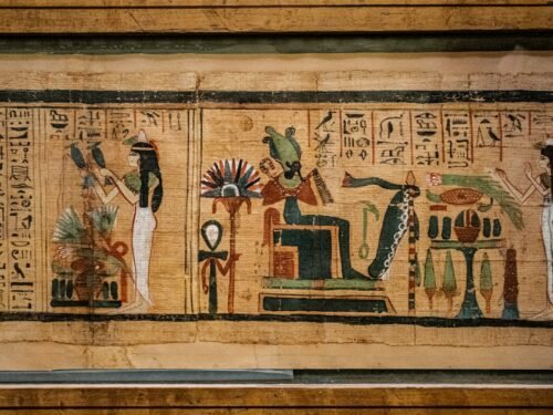 man in black suit standing on brown wooden door