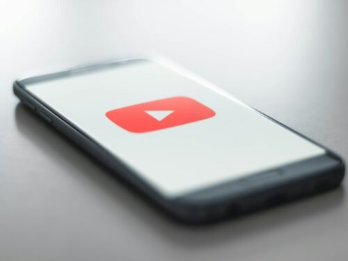 a close up of a cell phone with a youtube logo on it