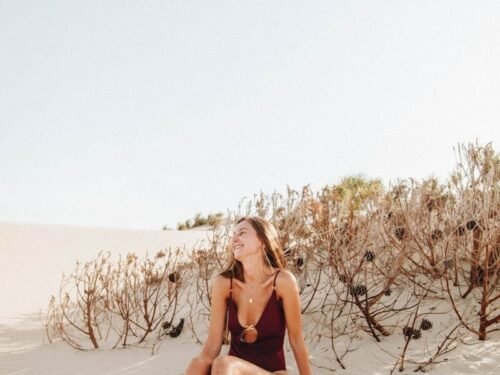 woman sitting on sand