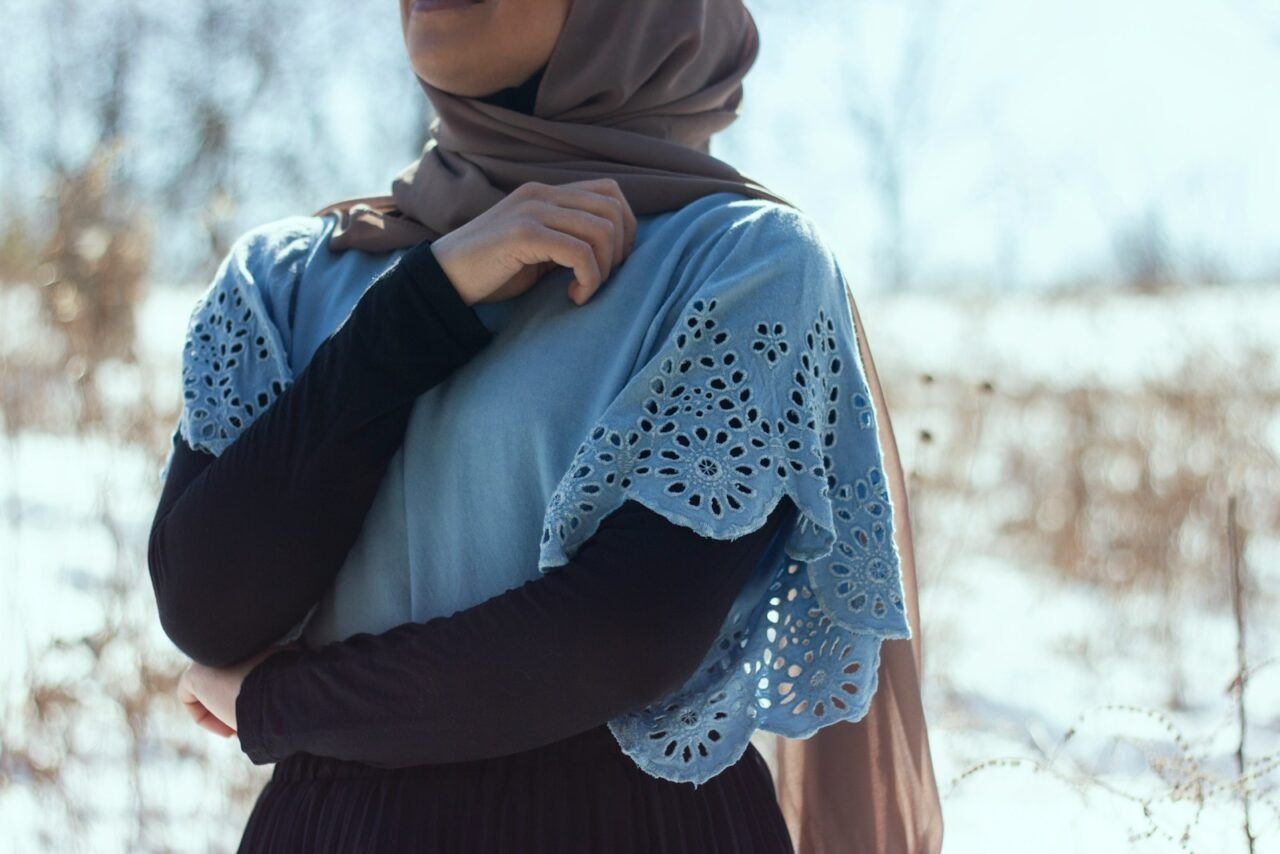 woman in blue hijab and white long sleeve shirt