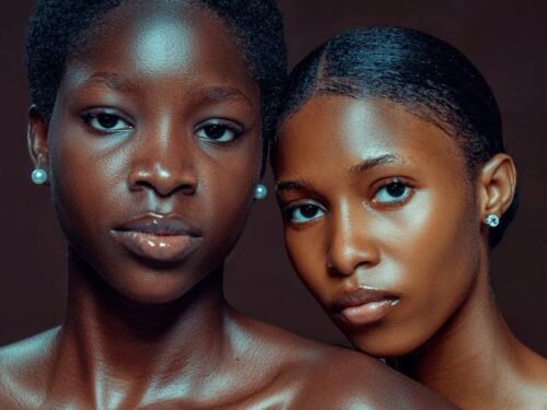 Two young black women with pearl earrings