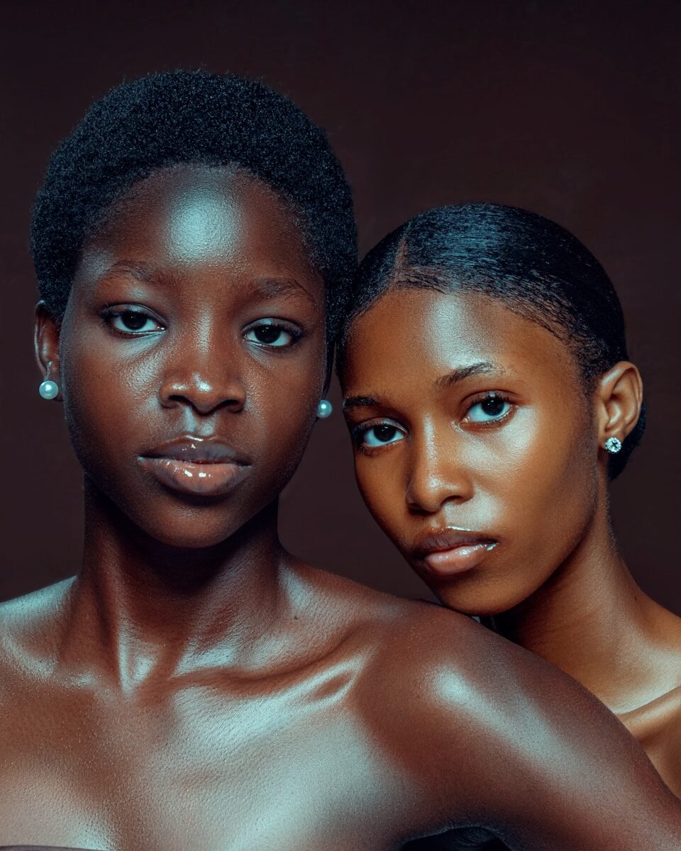 Two young black women with pearl earrings