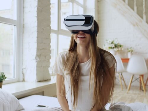 Young woman wearing vr headset and smiling