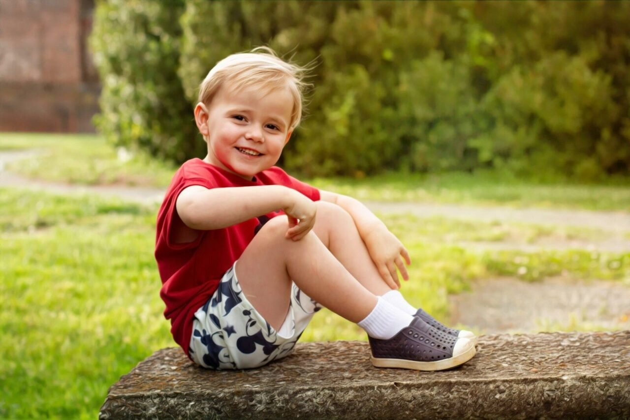 a little boy that is sitting on a bench