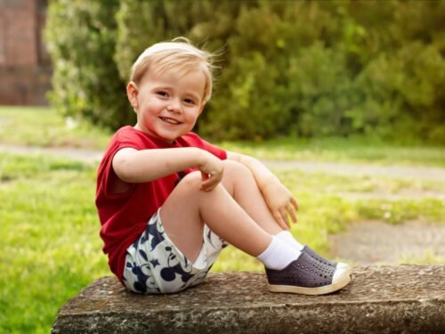 a little boy that is sitting on a bench