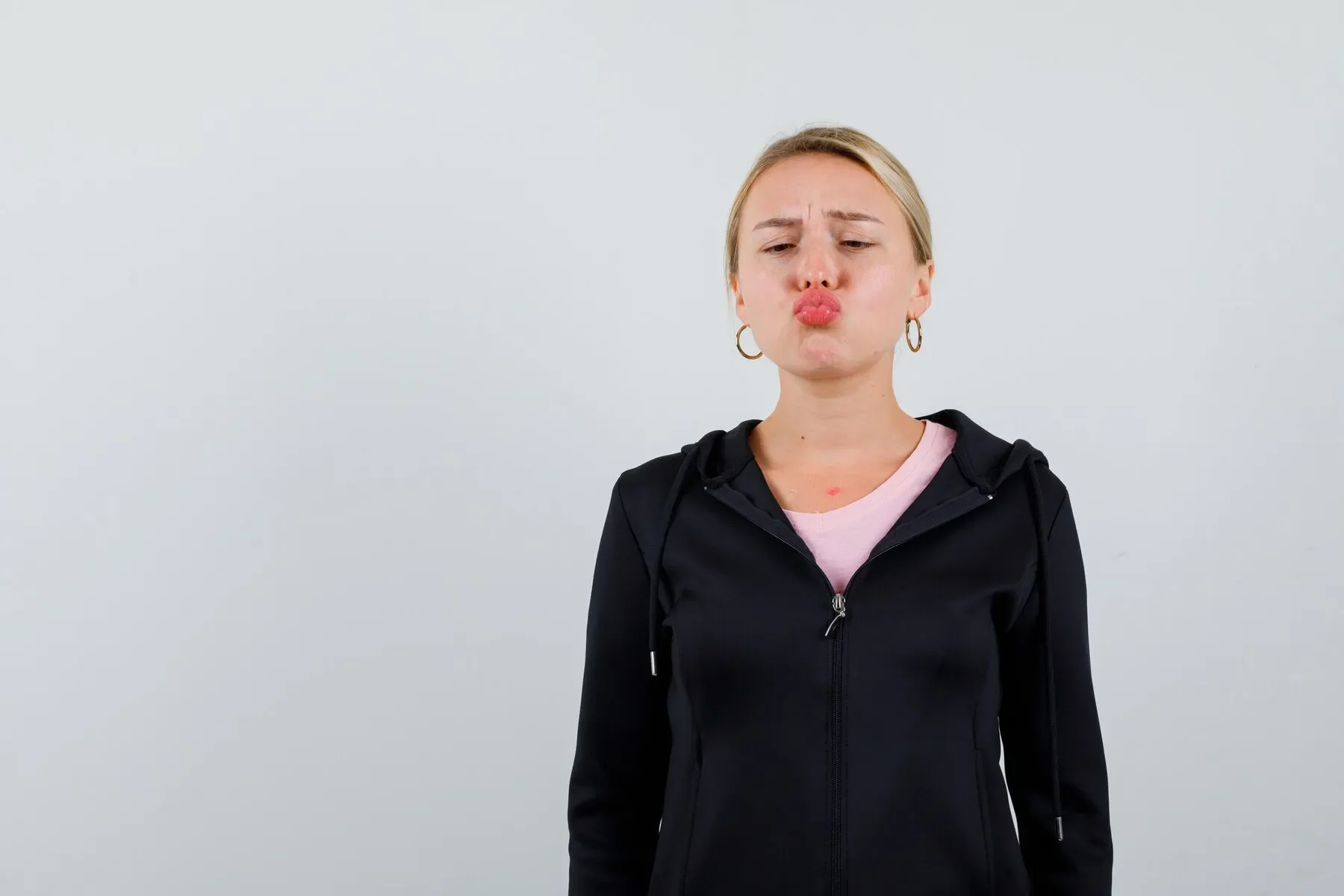 Young blonde woman black jacket