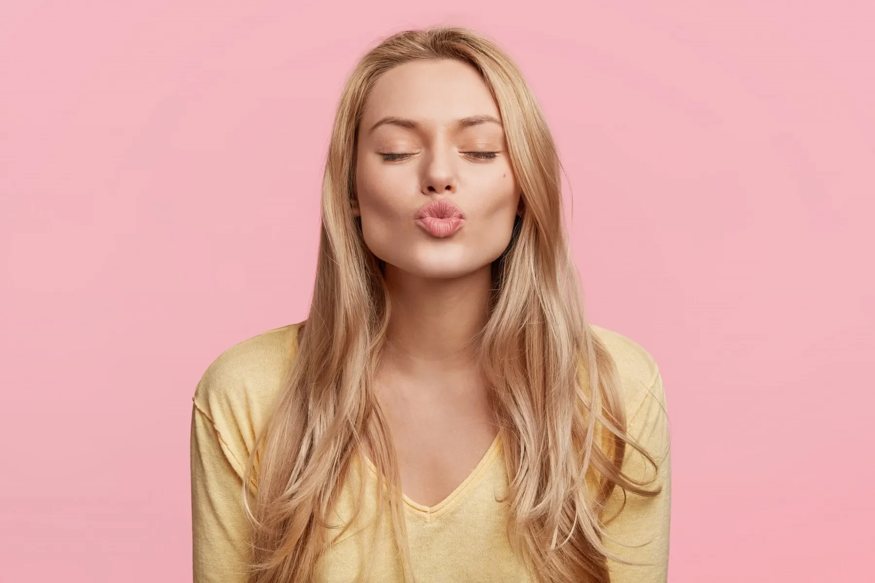 Young blonde woman with yellow sweater