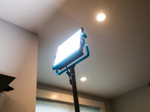 black flat screen tv turned on near white wall