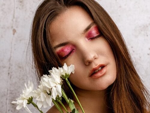 woman with white flower on her ear